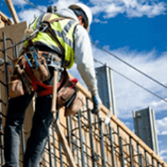 Construction Worker Harnessed Working on a Building